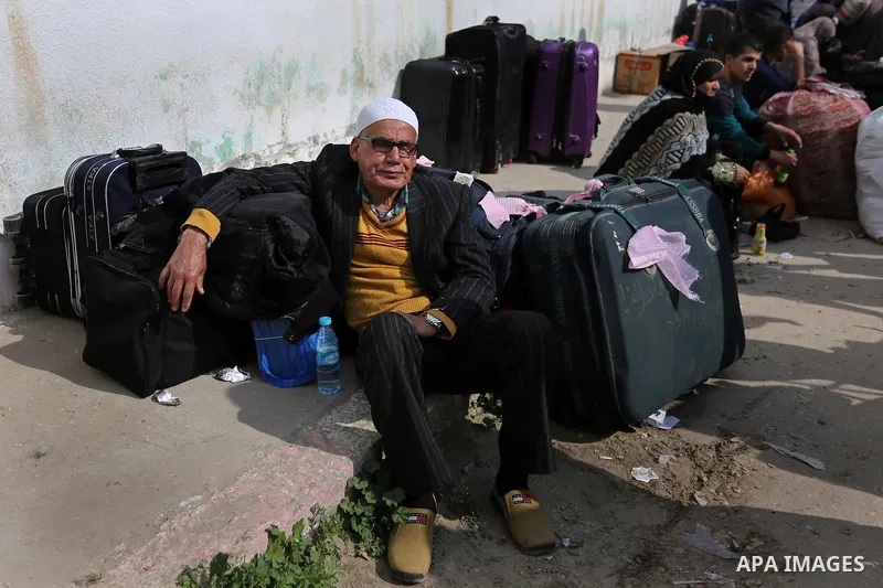 Palestinians wait for travel permits to cross into Egypt through the Rafah border crossing after it was opened by Egyptian authorities for humanitarian cases, in Rafah in the southern Gaza Strip on March 7, 2017. Photo b...