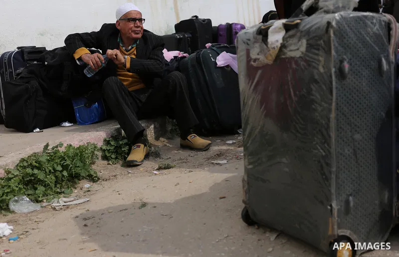 Palestinians wait for travel permits to cross into Egypt through the Rafah border crossing after it was opened by Egyptian authorities for humanitarian cases, in Rafah in the southern Gaza Strip on March 7, 2017. Photo b...