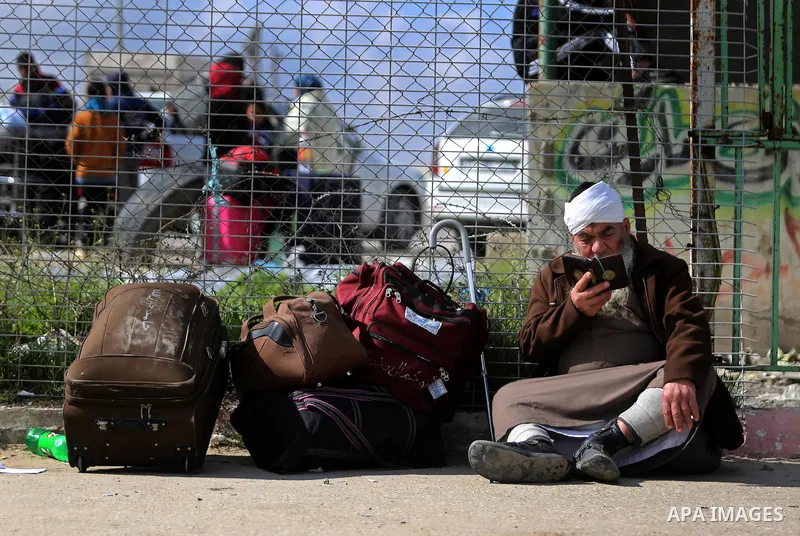 Palestinians wait for travel permits to cross into Egypt through the Rafah border crossing after it was opened by Egyptian authorities for humanitarian cases, in Rafah in the southern Gaza Strip on March 7, 2017. Photo b...