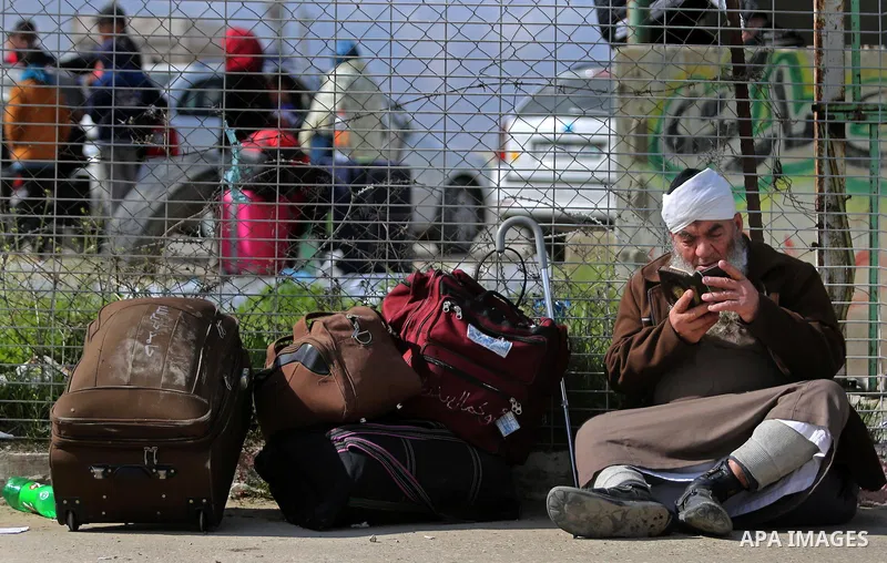 Palestinians wait for travel permits to cross into Egypt through the Rafah border crossing after it was opened by Egyptian authorities for humanitarian cases, in Rafah in the southern Gaza Strip on March 7, 2017. Photo b...