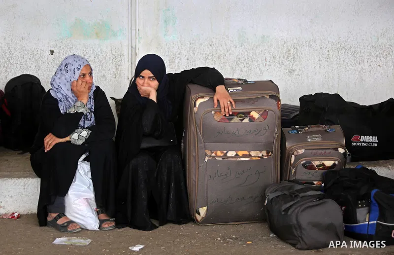 Palestinians wait for travel permits to cross into Egypt through the Rafah border crossing after it was opened by Egyptian authorities for humanitarian cases, in Rafah in the southern Gaza Strip on March 7, 2017. Photo b...