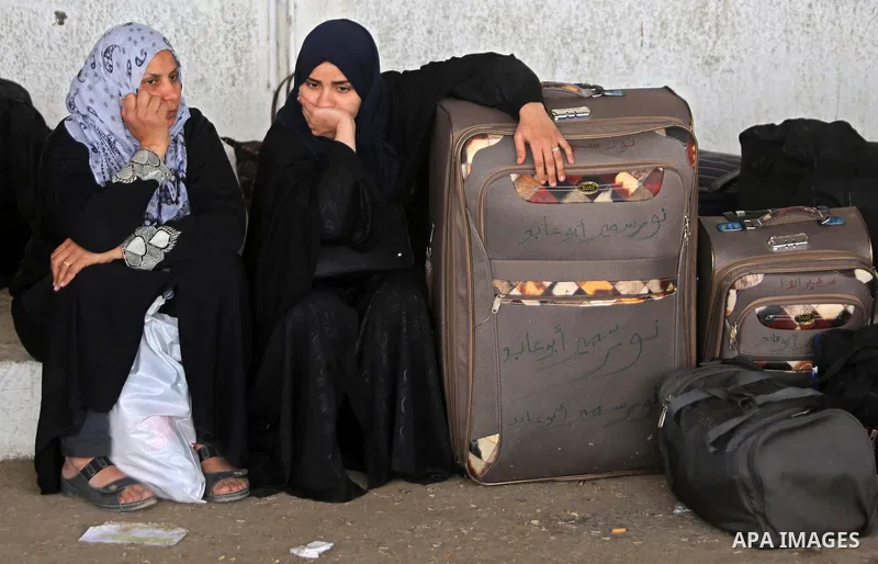 Palestinians wait for travel permits to cross into Egypt through the Rafah border crossing after it was opened by Egyptian authorities for humanitarian cases, in Rafah in the southern Gaza Strip on March 7, 2017. Photo b...