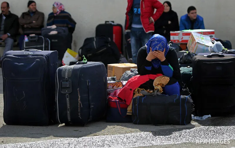 Palestinians wait for travel permits to cross into Egypt through the Rafah border crossing after it was opened by Egyptian authorities for humanitarian cases, in Rafah in the southern Gaza Strip on March 7, 2017. Photo b...