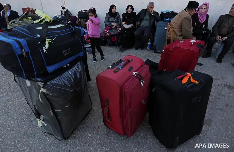 Palestinians wait for travel permits to cross into Egypt through the Rafah border crossing after it was opened by Egyptian authorities for humanitarian cases, in Rafah in the southern Gaza Strip on March 7, 2017. Photo b...