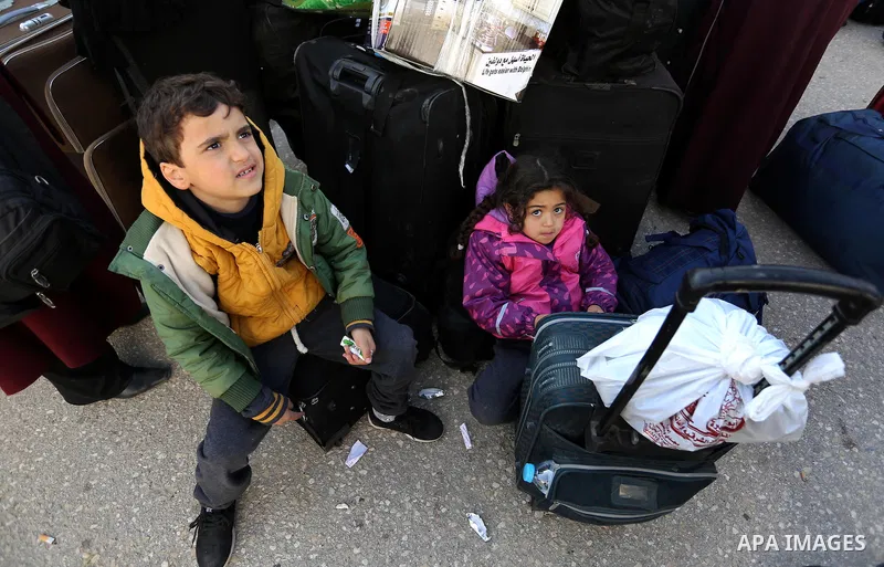Palestinians wait for travel permits to cross into Egypt through the Rafah border crossing after it was opened by Egyptian authorities for humanitarian cases, in Rafah in the southern Gaza Strip on March 7, 2017. Photo b...