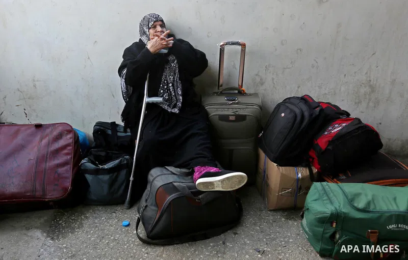 Palestinians wait for travel permits to cross into Egypt through the Rafah border crossing after it was opened by Egyptian authorities for humanitarian cases, in Rafah in the southern Gaza Strip on March 7, 2017. Photo b...