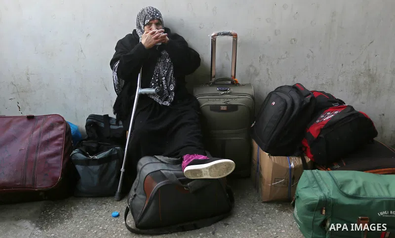 Palestinians wait for travel permits to cross into Egypt through the Rafah border crossing after it was opened by Egyptian authorities for humanitarian cases, in Rafah in the southern Gaza Strip on March 7, 2017. Photo b...