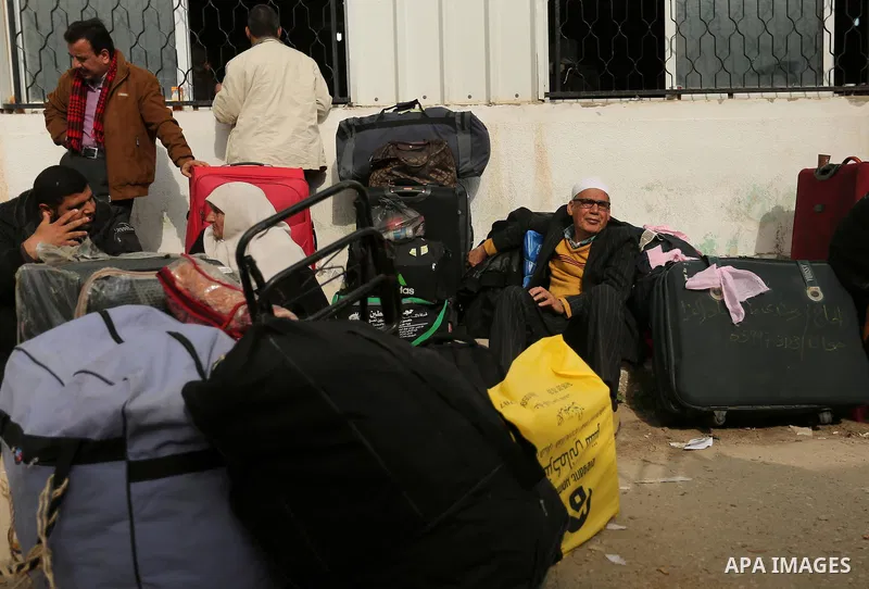 Palestinians wait for travel permits to cross into Egypt through the Rafah border crossing after it was opened by Egyptian authorities for humanitarian cases, in Rafah in the southern Gaza Strip on March 7, 2017. Photo b...