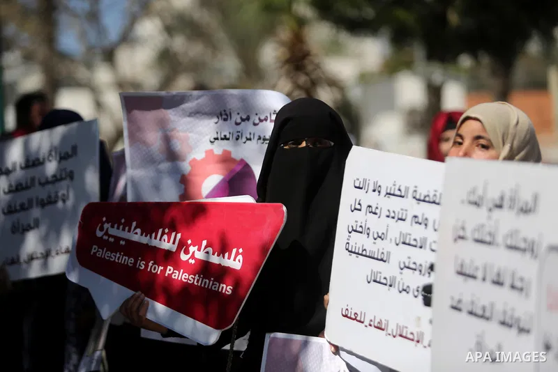 Palestinian women take part during a protest against violence towards women and demanding to end the Israeli occupation on International Women's Day, in Gaza city on March 08, 2017. Photo by Ashraf Amra