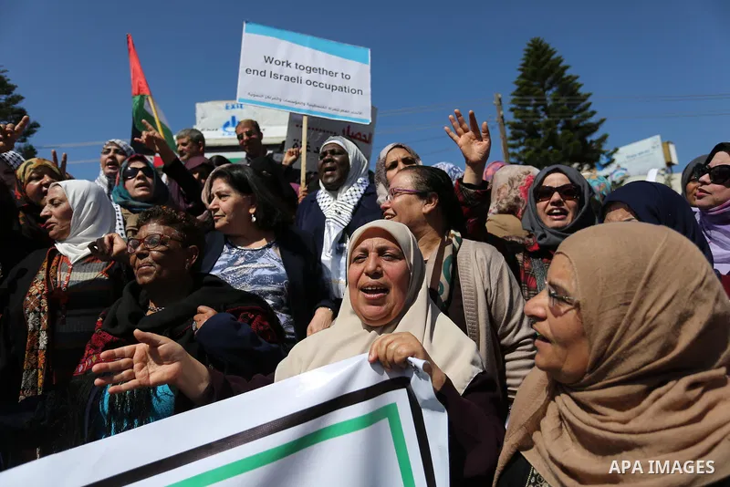 Palestinian women take part during a protest against violence towards women and demanding to end the Israeli occupation on International Women's Day, in Gaza city on March 08, 2017. Photo by Ashraf Amra