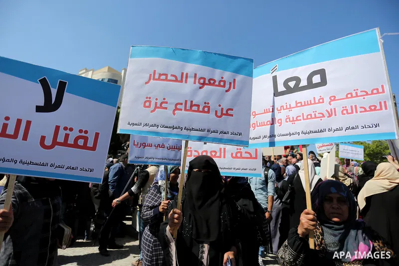 Palestinian women take part during a protest against violence towards women and demanding to end the Israeli occupation on International Women's Day, in Gaza city on March 08, 2017. Photo by Ashraf Amra