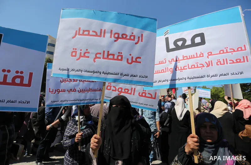 Palestinian women take part during a protest against violence towards women and demanding to end the Israeli occupation on International Women's Day, in Gaza city on March 08, 2017. Photo by Ashraf Amra