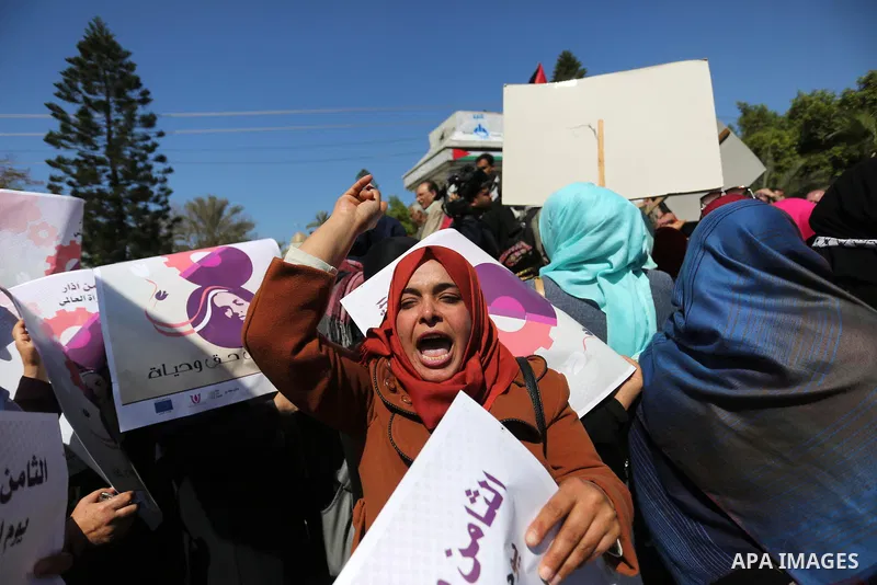 Palestinian women take part during a protest against violence towards women and demanding to end the Israeli occupation on International Women's Day, in Gaza city on March 08, 2017. Photo by Ashraf Amra