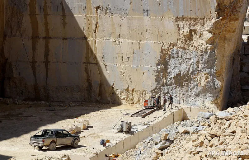 Palestinian labourers work at a quarry in the West Bank village of Taffouh near Hebron, 08 March 2017. According to the Palestinian Union of Stone and Marble, the stone and marble sector is considered to be one of the mo...