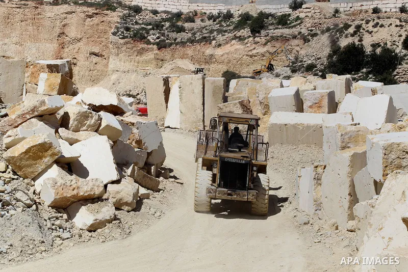 Palestinian labourers work at a quarry in the West Bank village of Taffouh near Hebron, 08 March 2017. According to the Palestinian Union of Stone and Marble, the stone and marble sector is considered to be one of the mo...