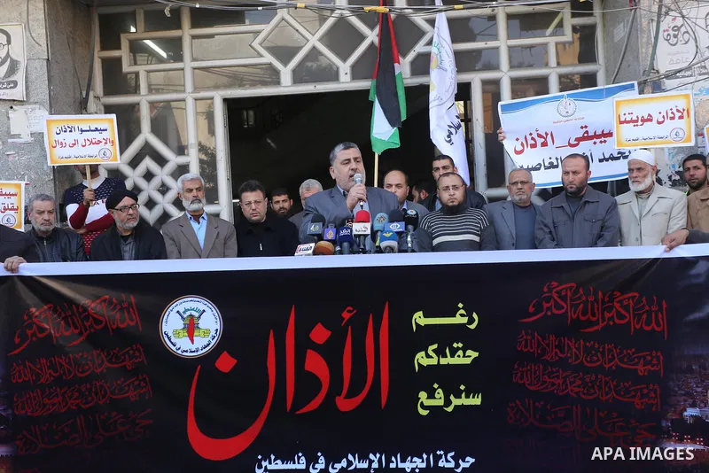 Palestinian supporters of the Islamic Jihad Movement hold banners during a protest against a controversial Israeli bill to limit the volume of calls to prayer at mosques in the occupied Jerusalem, in Gaza city on March 9...