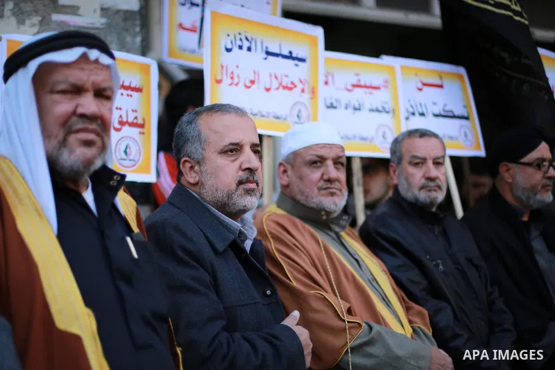 Palestinian supporters of the Islamic Jihad Movement hold banners during a protest against a controversial Israeli bill to limit the volume of calls to prayer at mosques in the occupied Jerusalem, in Gaza city on March 9...