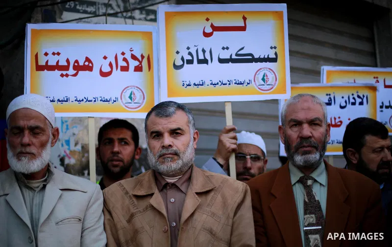 Palestinian supporters of the Islamic Jihad Movement hold banners during a protest against a controversial Israeli bill to limit the volume of calls to prayer at mosques in the occupied Jerusalem, in Gaza city on March 9...