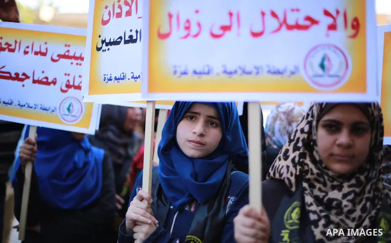 Palestinian supporters of the Islamic Jihad Movement hold banners during a protest against a controversial Israeli bill to limit the volume of calls to prayer at mosques in the occupied Jerusalem, in Gaza city on March 9...