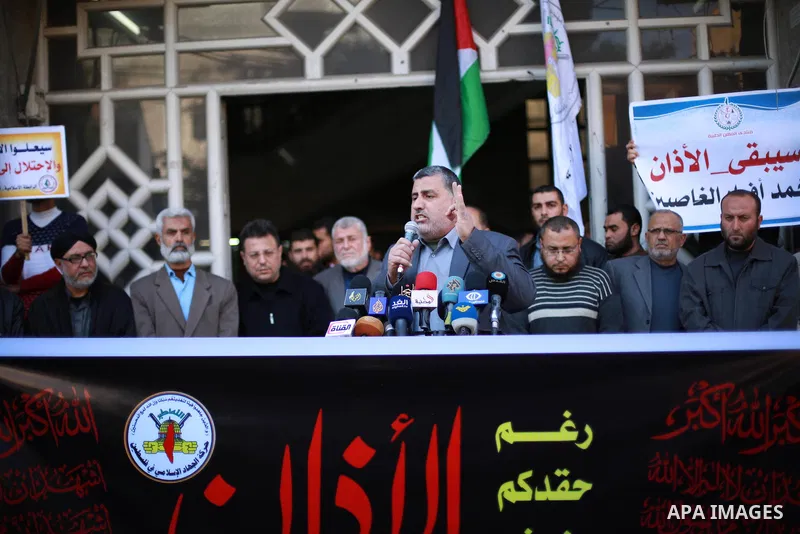 Palestinian supporters of the Islamic Jihad Movement hold banners during a protest against a controversial Israeli bill to limit the volume of calls to prayer at mosques in the occupied Jerusalem, in Gaza city on March 9...