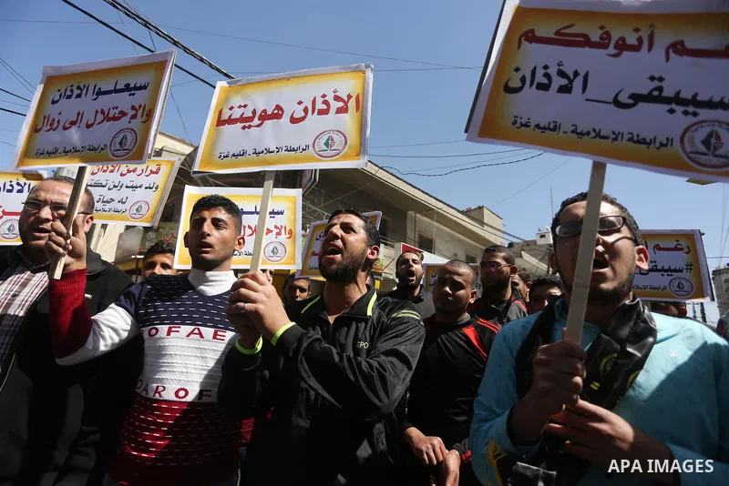 Palestinian supporters of the Islamic Jihad Movement hold banners during a protest against a controversial Israeli bill to limit the volume of calls to prayer at mosques in the occupied Jerusalem, in Gaza city on March 9...