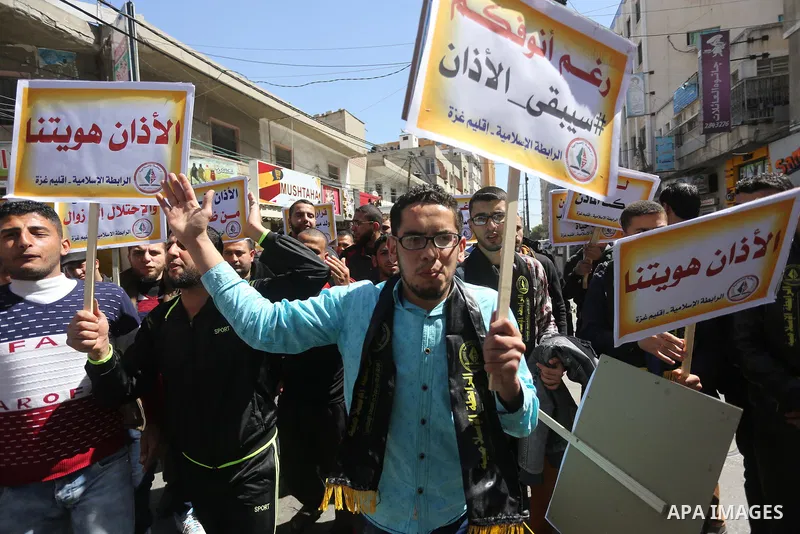 Palestinian supporters of the Islamic Jihad Movement hold banners during a protest against a controversial Israeli bill to limit the volume of calls to prayer at mosques in the occupied Jerusalem, in Gaza city on March 9...