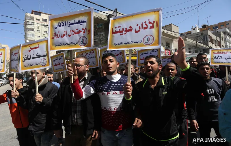 Palestinian supporters of the Islamic Jihad Movement hold banners during a protest against a controversial Israeli bill to limit the volume of calls to prayer at mosques in the occupied Jerusalem, in Gaza city on March 9...