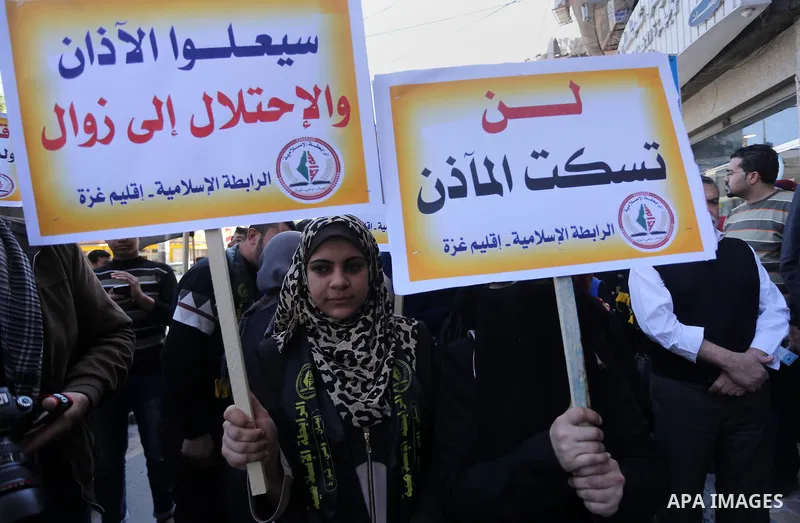 Palestinian supporters of the Islamic Jihad Movement hold banners during a protest against a controversial Israeli bill to limit the volume of calls to prayer at mosques in the occupied Jerusalem, in Gaza city on March 9...