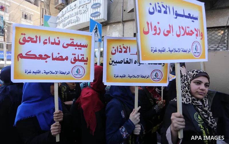 Palestinian supporters of the Islamic Jihad Movement hold banners during a protest against a controversial Israeli bill to limit the volume of calls to prayer at mosques in the occupied Jerusalem, in Gaza city on March 9...