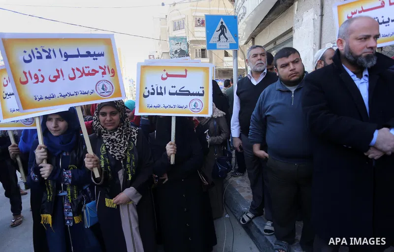 Palestinian supporters of the Islamic Jihad Movement hold banners during a protest against a controversial Israeli bill to limit the volume of calls to prayer at mosques in the occupied Jerusalem, in Gaza city on March 9...