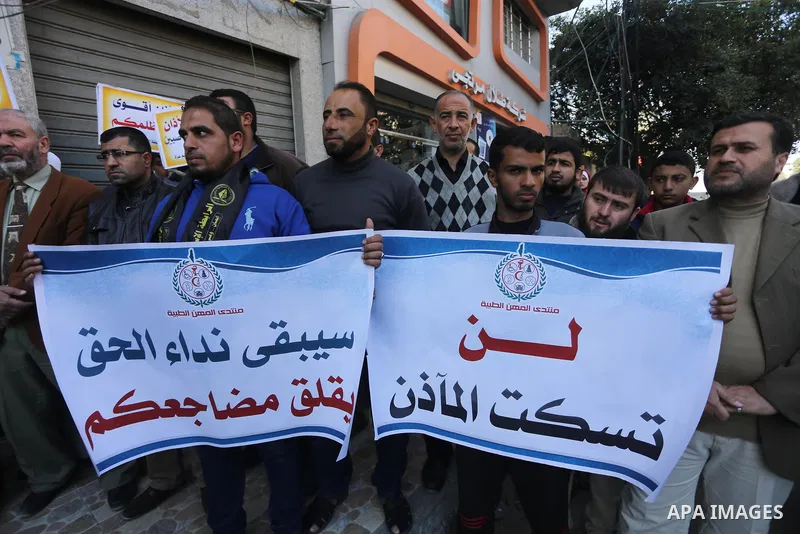 Palestinian supporters of the Islamic Jihad Movement hold banners during a protest against a controversial Israeli bill to limit the volume of calls to prayer at mosques in the occupied Jerusalem, in Gaza city on March 9...