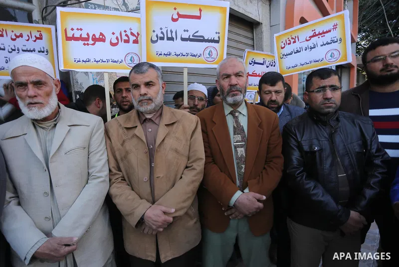 Palestinian supporters of the Islamic Jihad Movement hold banners during a protest against a controversial Israeli bill to limit the volume of calls to prayer at mosques in the occupied Jerusalem, in Gaza city on March 9...