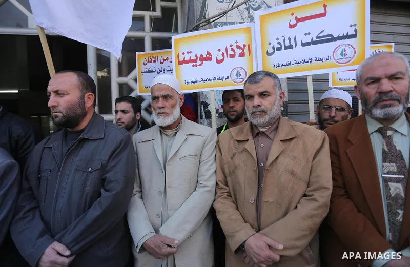 Palestinian supporters of the Islamic Jihad Movement hold banners during a protest against a controversial Israeli bill to limit the volume of calls to prayer at mosques in the occupied Jerusalem, in Gaza city on March 9...