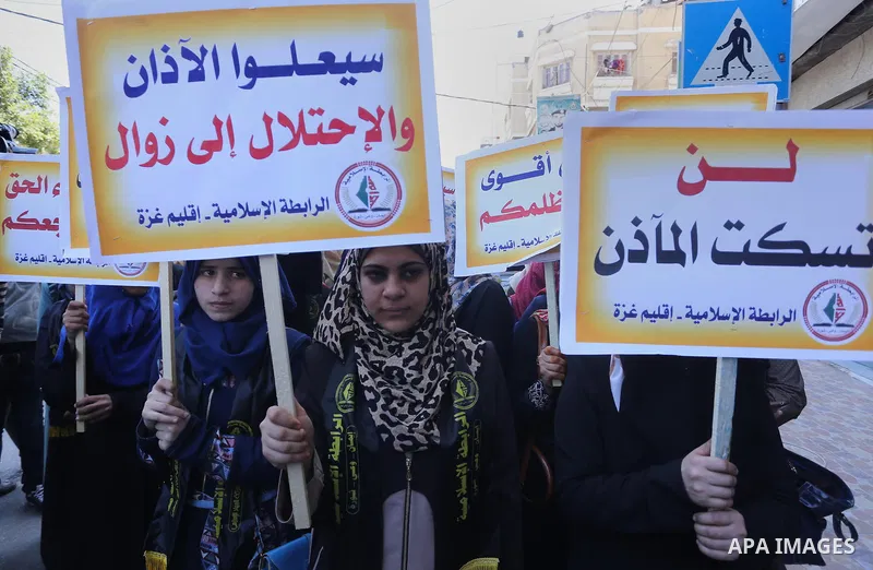 Palestinian supporters of the Islamic Jihad Movement hold banners during a protest against a controversial Israeli bill to limit the volume of calls to prayer at mosques in the occupied Jerusalem, in Gaza city on March 9...