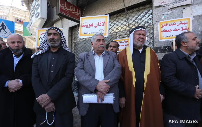 Palestinian supporters of the Islamic Jihad Movement hold banners during a protest against a controversial Israeli bill to limit the volume of calls to prayer at mosques in the occupied Jerusalem, in Gaza city on March 9...