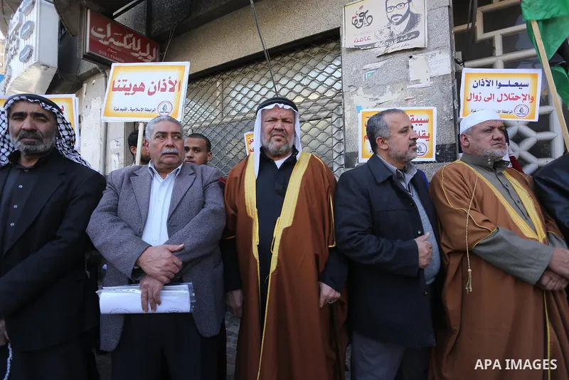 Palestinian supporters of the Islamic Jihad Movement hold banners during a protest against a controversial Israeli bill to limit the volume of calls to prayer at mosques in the occupied Jerusalem, in Gaza city on March 9...