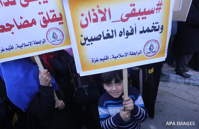 Palestinian supporters of the Islamic Jihad Movement hold banners during a protest against a controversial Israeli bill to limit the volume of calls to prayer at mosques in the occupied Jerusalem, in Gaza city on March 9...