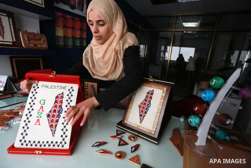 Noor Jaber, a Palestinian woman works on embroidery on wood, at her workshop in Gaza city on March 11, 2017. Photo by Mohammed Asad