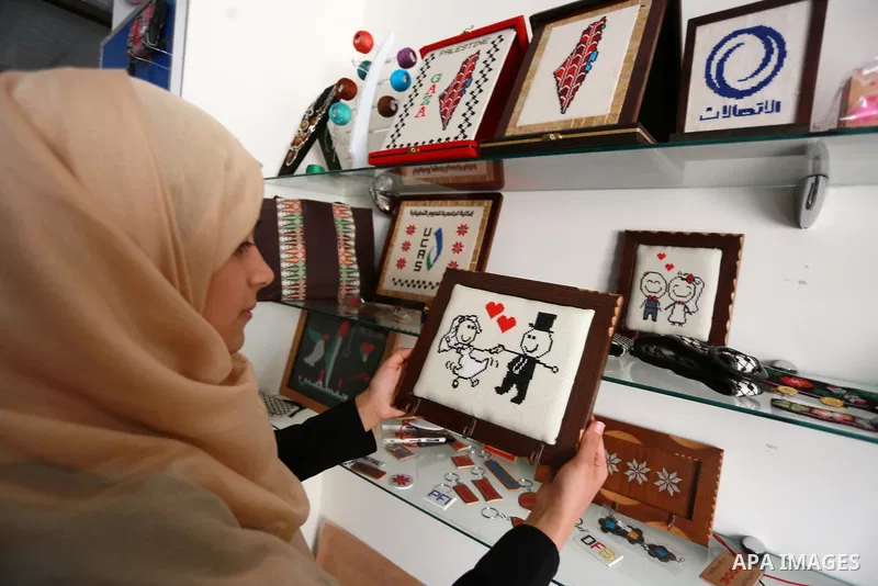 Noor Jaber, a Palestinian woman works on embroidery on wood, at her workshop in Gaza city on March 11, 2017. Photo by Mohammed Asad