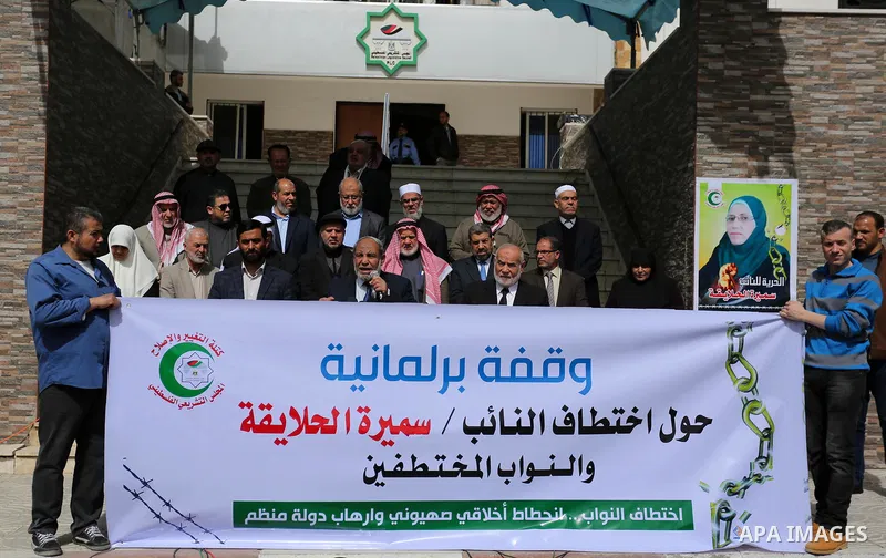 Palestinian Members of the Legislative council take part in a protest against arrest oh the Parliament deputy of Hamas, Samira Halaika, in Gaza city, on March 12, 2017. Photo by Ashraf Amra