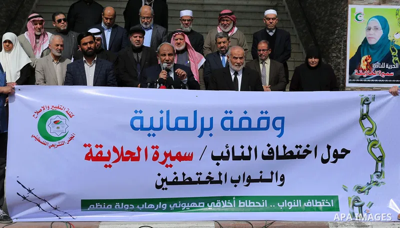 Palestinian Members of the Legislative council take part in a protest against arrest oh the Parliament deputy of Hamas, Samira Halaika, in Gaza city, on March 12, 2017. Photo by Ashraf Amra