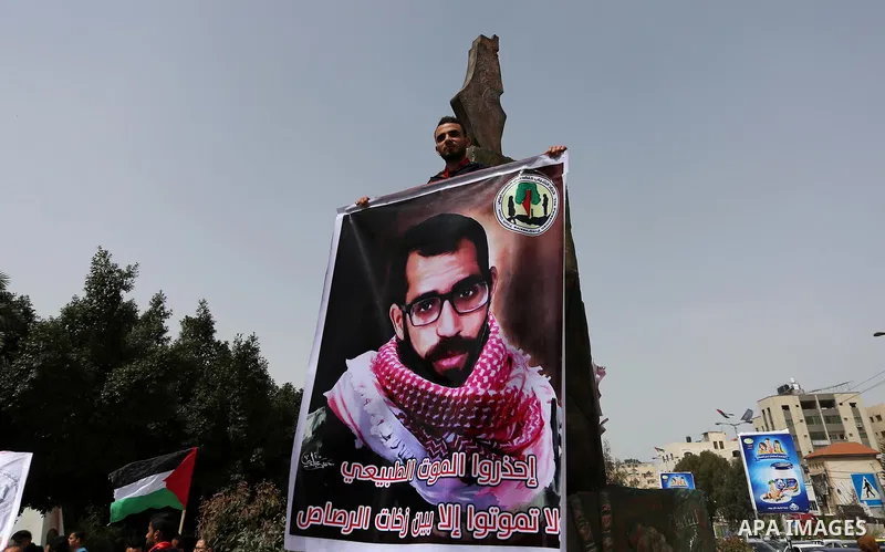 Palestinian supporters of the Popular Front for the Liberation of Palestine (PFLP), hold placards during a protest against the trial of the martyr, Bassel al-Aaraj, and the security coordination in Gaza City, on March 12...
