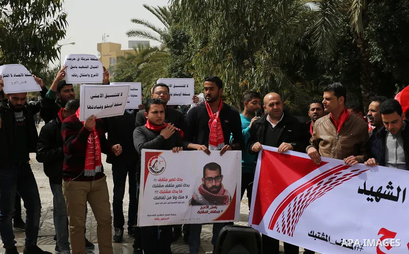 Palestinian supporters of the Popular Front for the Liberation of Palestine (PFLP), hold placards during a protest against the trial of the martyr, Bassel al-Aaraj, and the security coordination in Gaza City, on March 12...