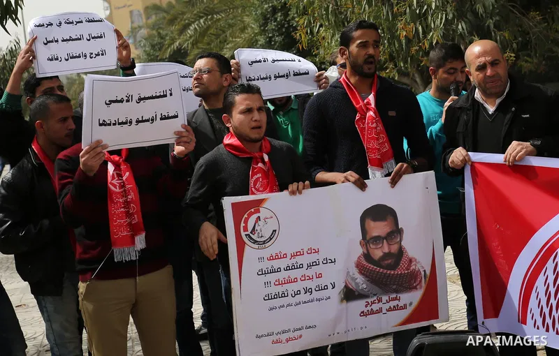 Palestinian supporters of the Popular Front for the Liberation of Palestine (PFLP), hold placards during a protest against the trial of the martyr, Bassel al-Aaraj, and the security coordination in Gaza City, on March 12...