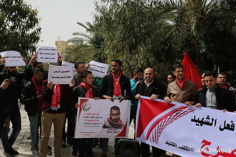 Palestinian supporters of the Popular Front for the Liberation of Palestine (PFLP), hold placards during a protest against the trial of the martyr, Bassel al-Aaraj, and the security coordination in Gaza City, on March 12...