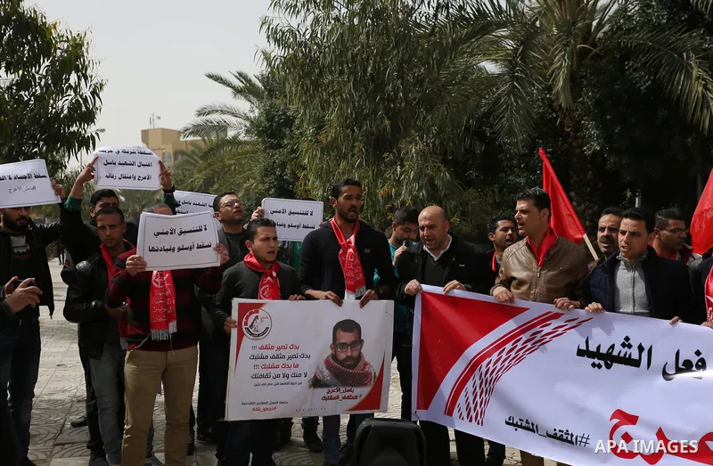 Palestinian supporters of the Popular Front for the Liberation of Palestine (PFLP), hold placards during a protest against the trial of the martyr, Bassel al-Aaraj, and the security coordination in Gaza City, on March 12...