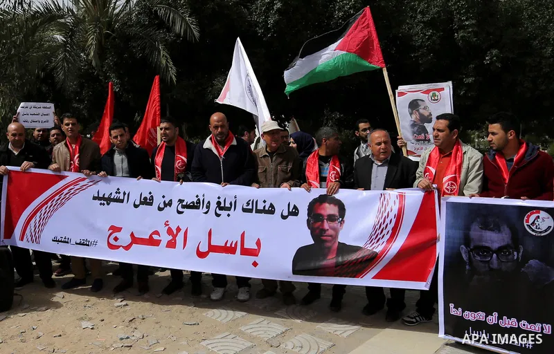 Palestinian supporters of the Popular Front for the Liberation of Palestine (PFLP), hold placards during a protest against the trial of the martyr, Bassel al-Aaraj, and the security coordination in Gaza City, on March 12...