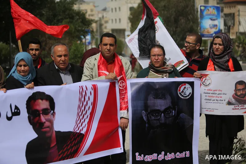 Palestinian supporters of the Popular Front for the Liberation of Palestine (PFLP), hold placards during a protest against the trial of the martyr, Bassel al-Aaraj, and the security coordination in Gaza City, on March 12...