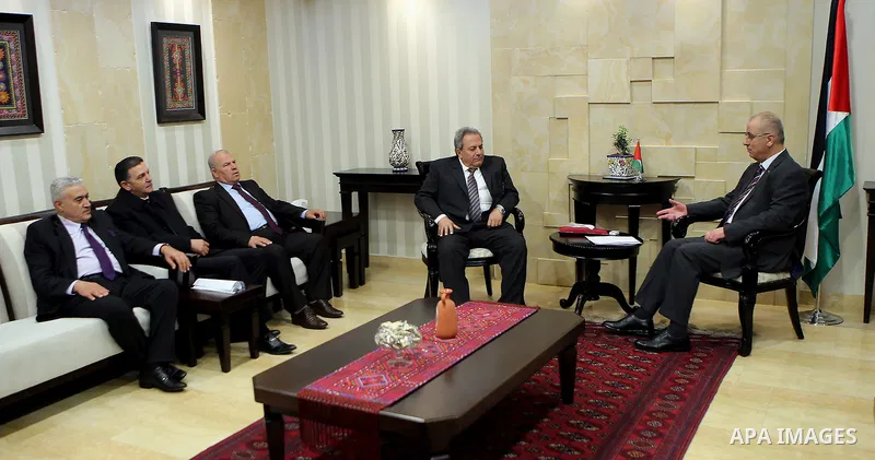 Palestinian Prime Minister Rami Hamdallah meets with Constitutional Court Chairman Mohammed Alhaji Qasim, in the West Bank city of Ramallah, on March 13, 2017. Photo by Prime Minister Office