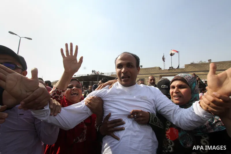 Released detainees wave to their relatives after Egyptian President Abdel Fattah al-Sisi issued a pardon for 203 youths jailed for taking part in demonstrations, as part of a pledge he made months ago to amend a protest...